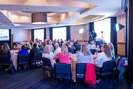 An audience listening to a presentation